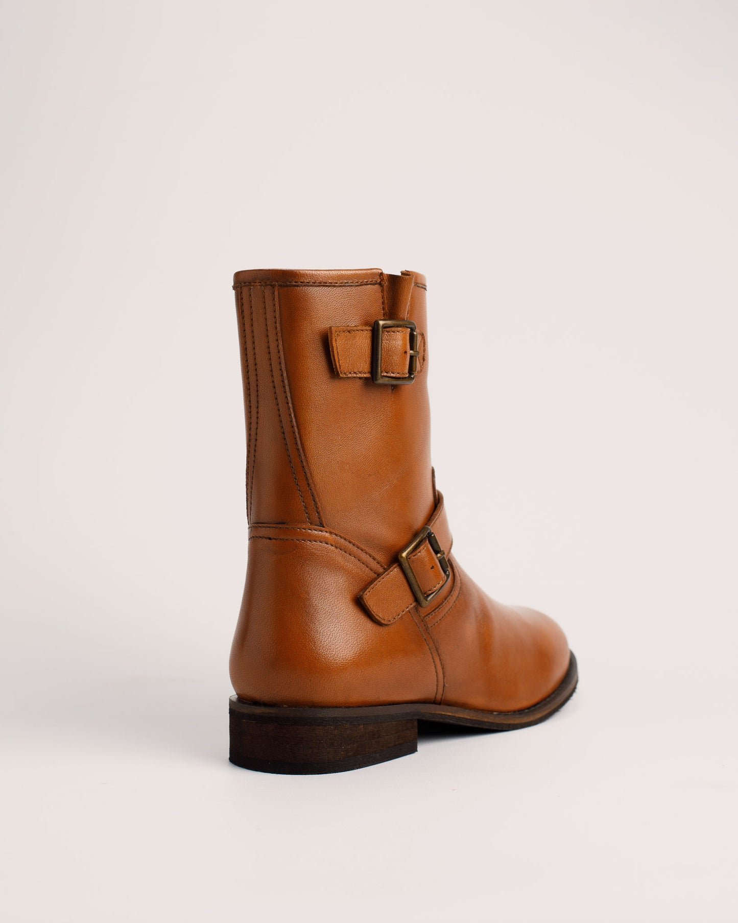 Detail of cognac leather texture and buckle on Lisa ankle boots