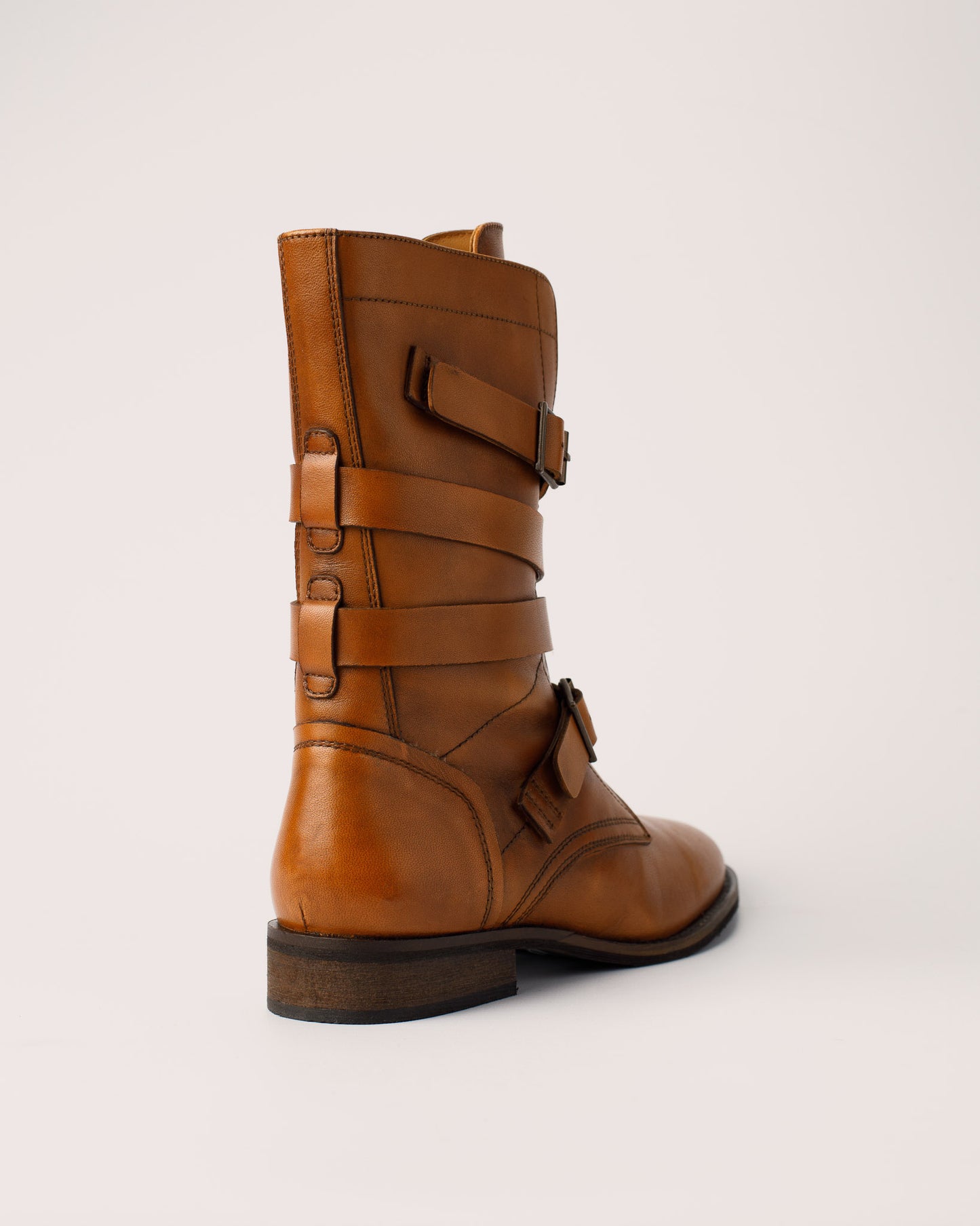 Detail of leather buckle strap design on Courtney cognac boots