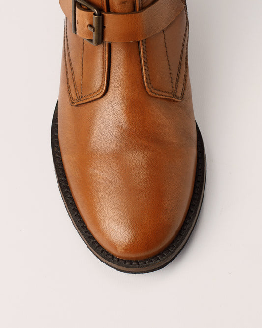 Detail of leather buckle strap design on Courtney cognac boots
