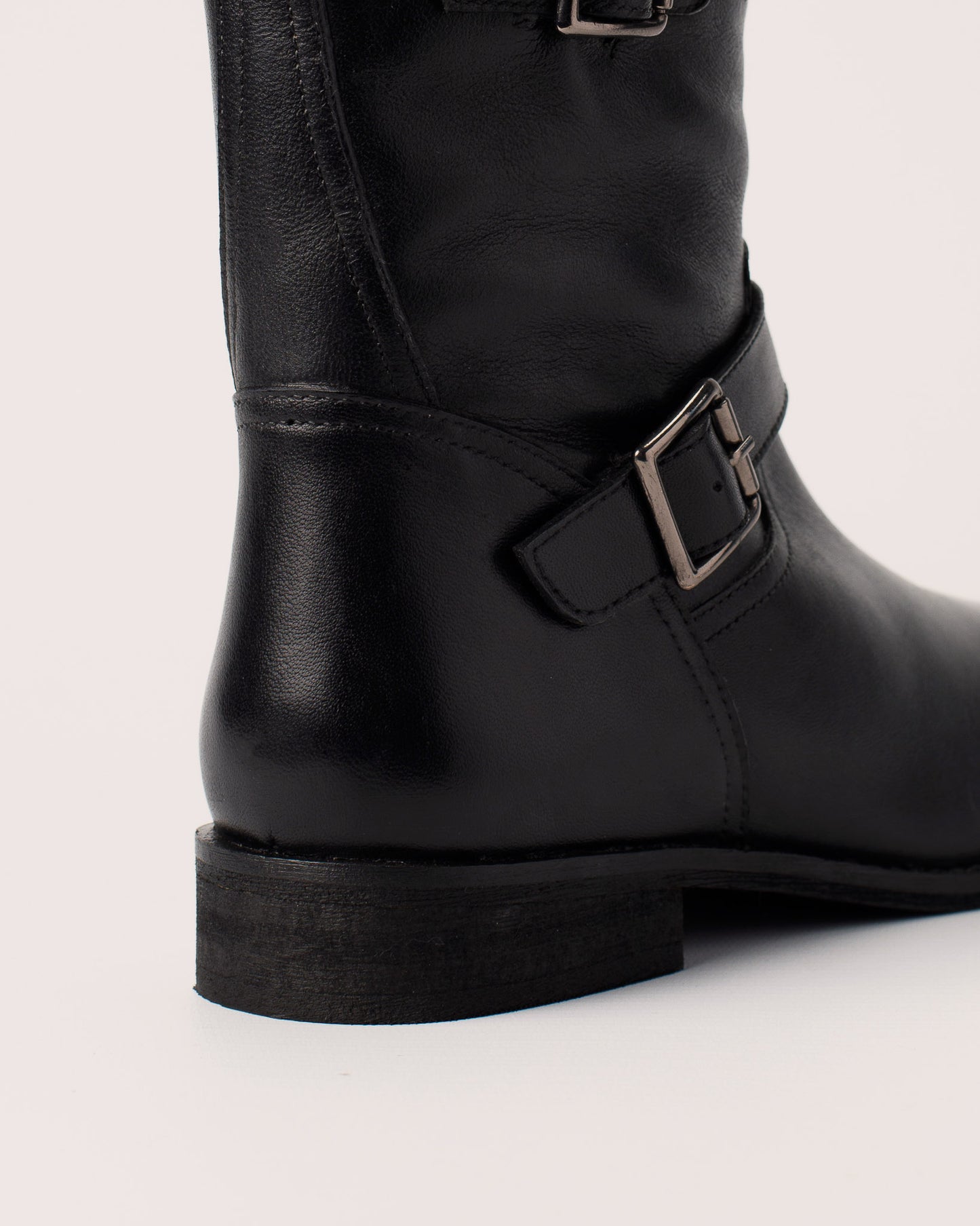 Side view of Lisa black leather ankle boots with double buckle details