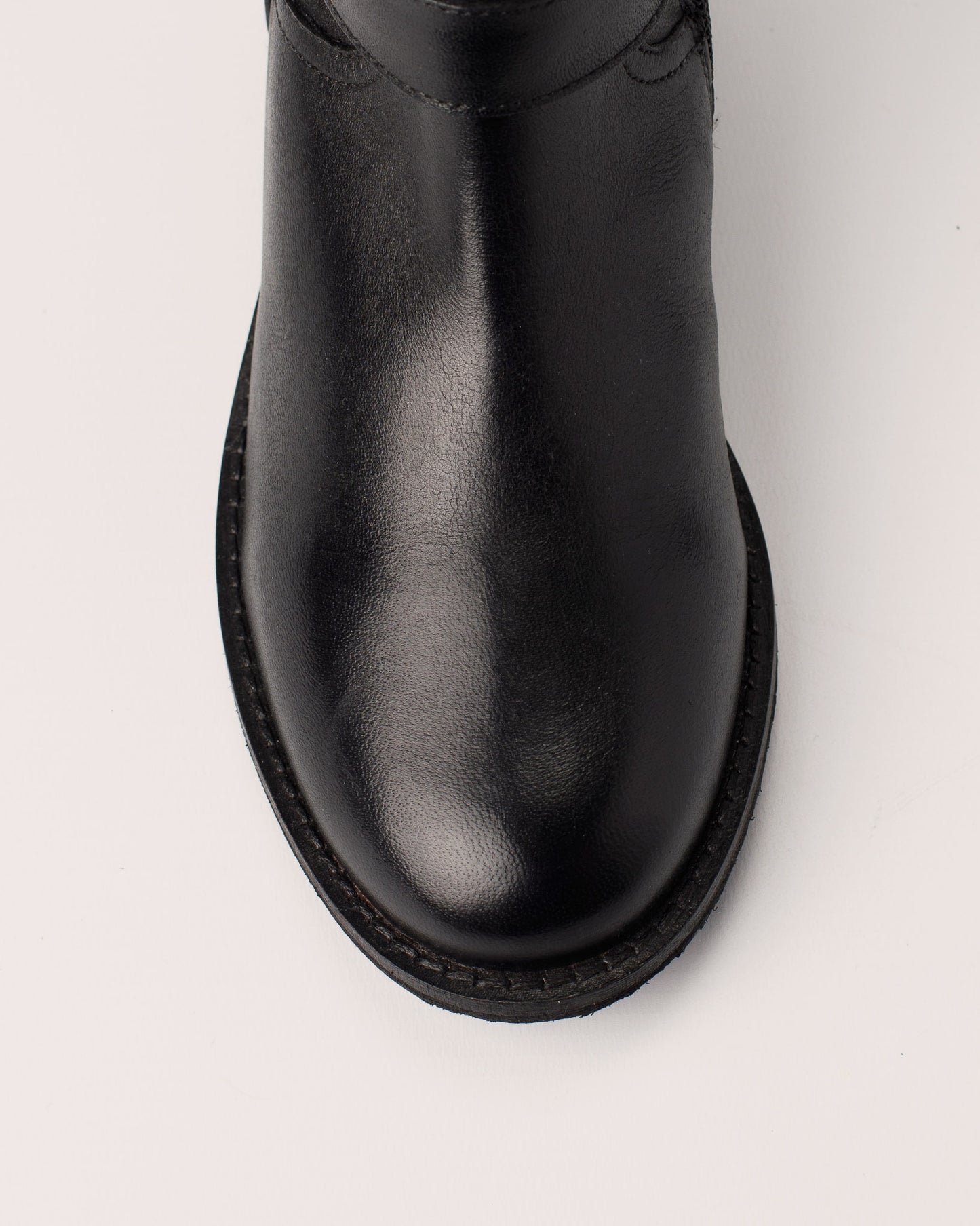 Side view of Lisa black leather ankle boots with double buckle details