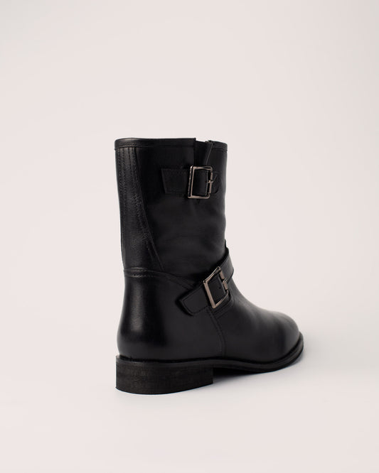Side view of Lisa black leather ankle boots with double buckle details